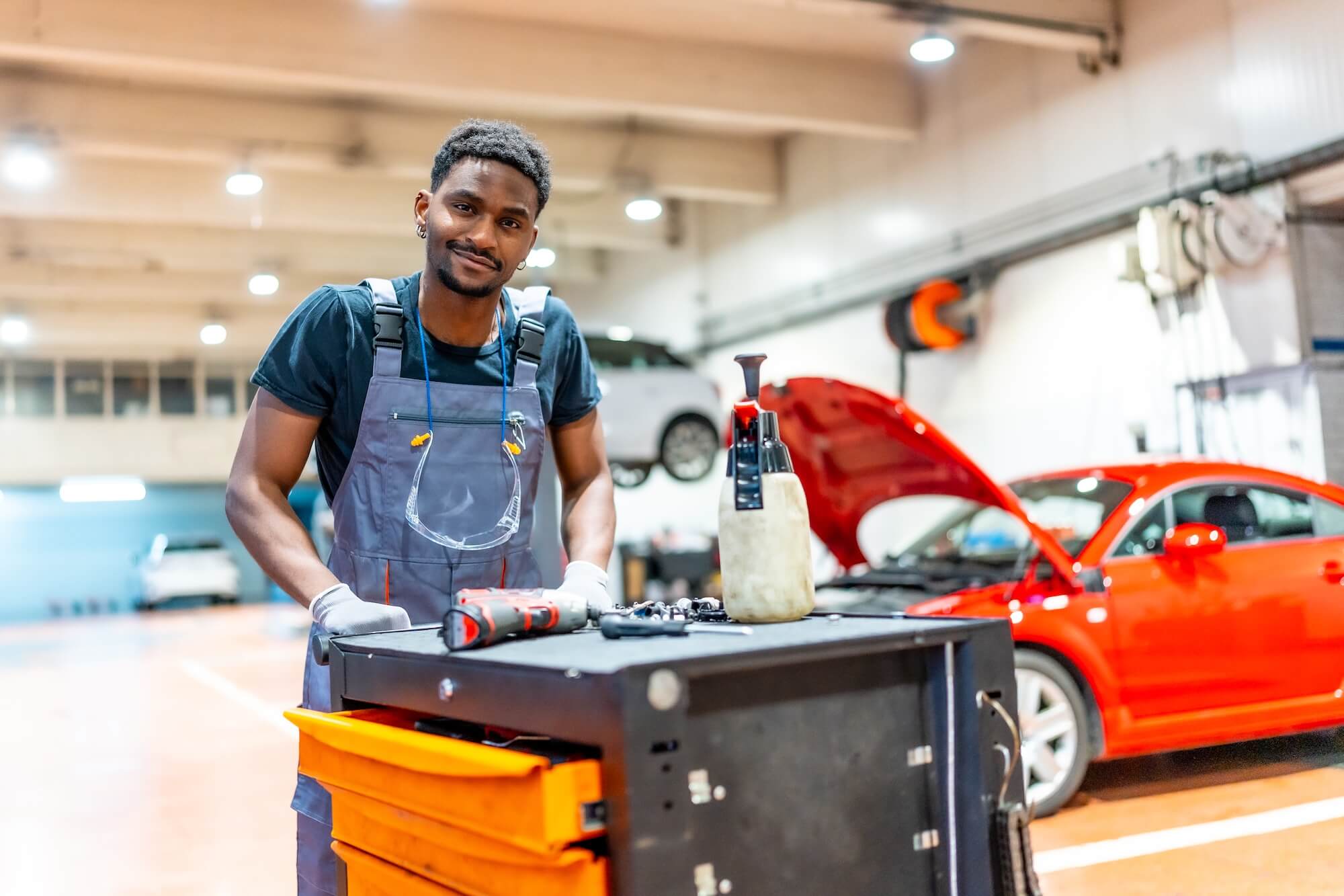 car-mechanic-pushing-tool-trolley-in-auto-repair-s-2025-05-13-05-47-05-utc